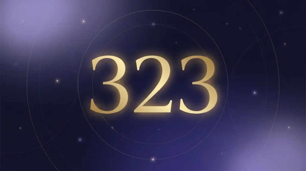 Angel number 323 in gold numerals on a starry midnight sky